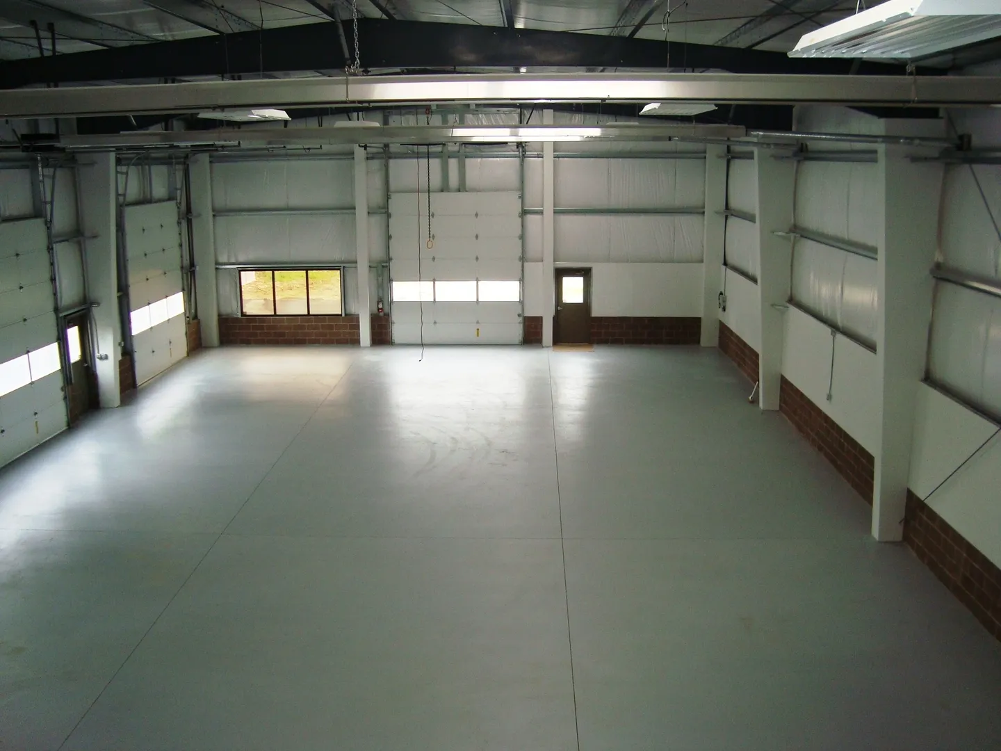 A large empty warehouse with lots of windows.